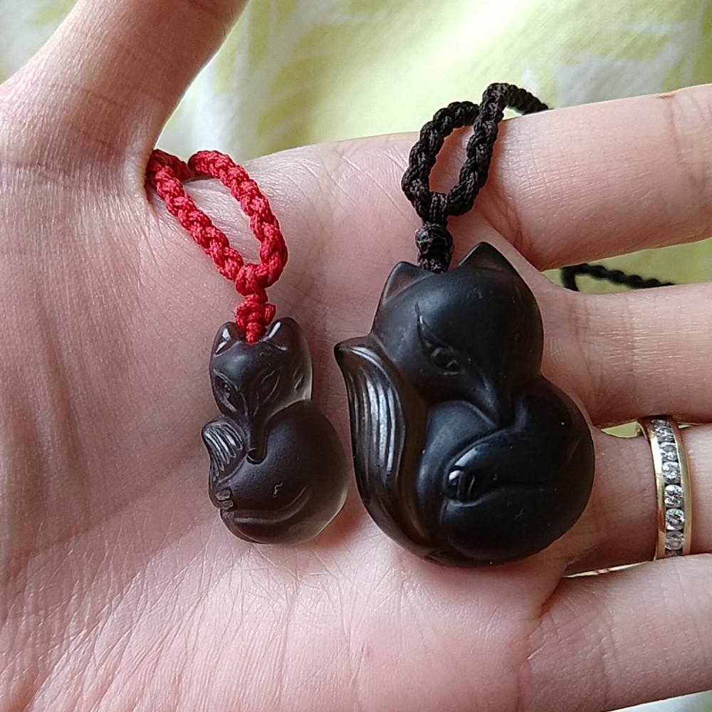 Two cute fox pendants made of onyx
